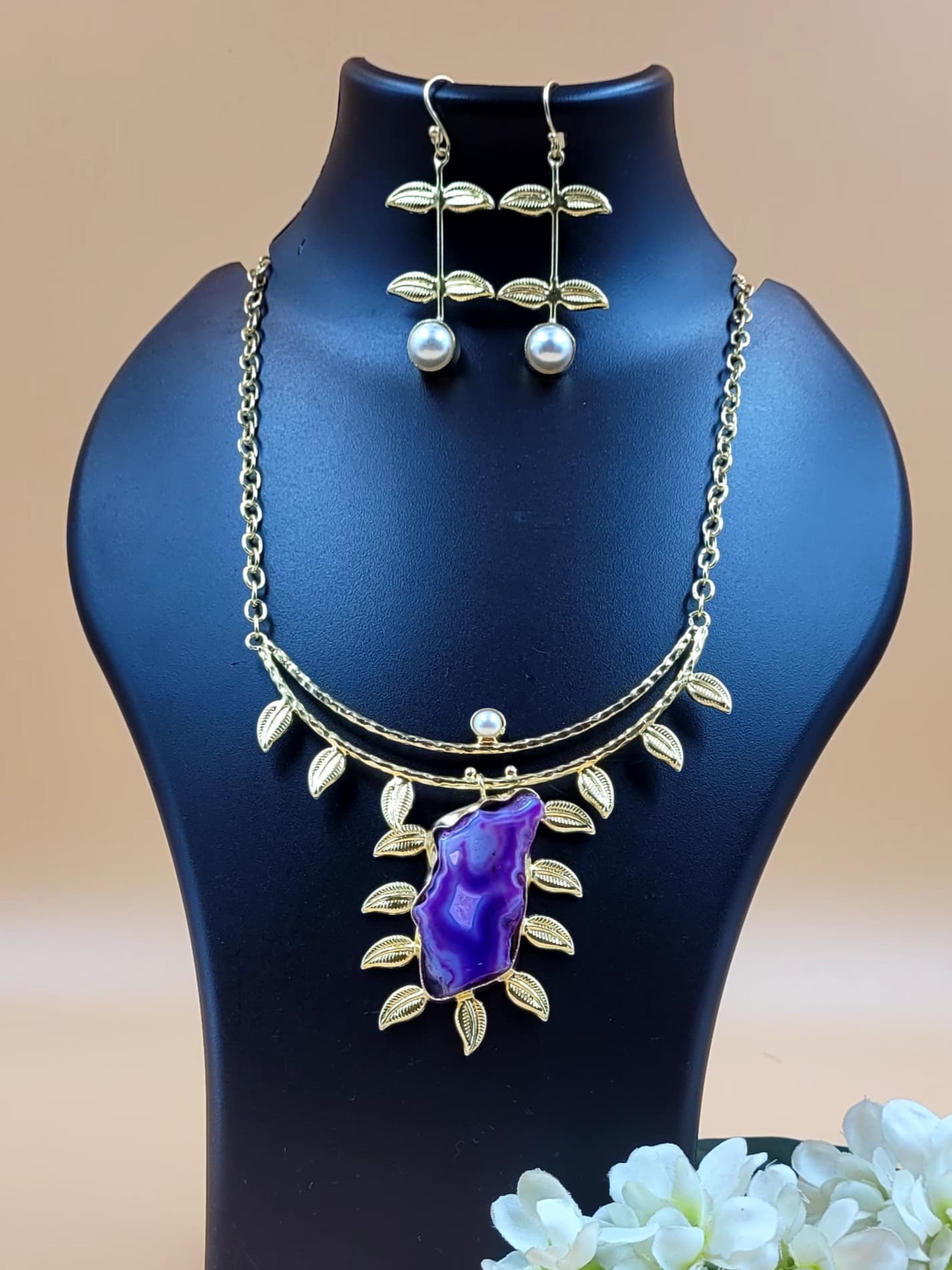 Leaf Designed Hasli Style Handmade Golden Brass Necklace Set With Raw Purple Stone